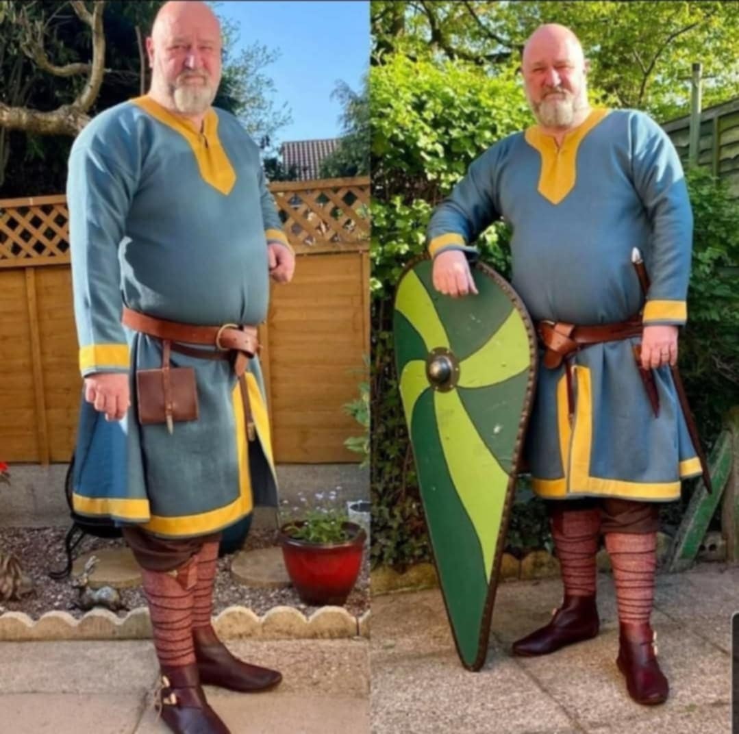 Blue Garment Worn by Man with Shield