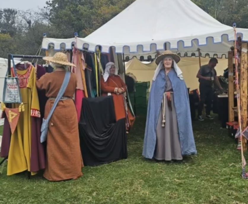 Woman in Cloak Next to Tent